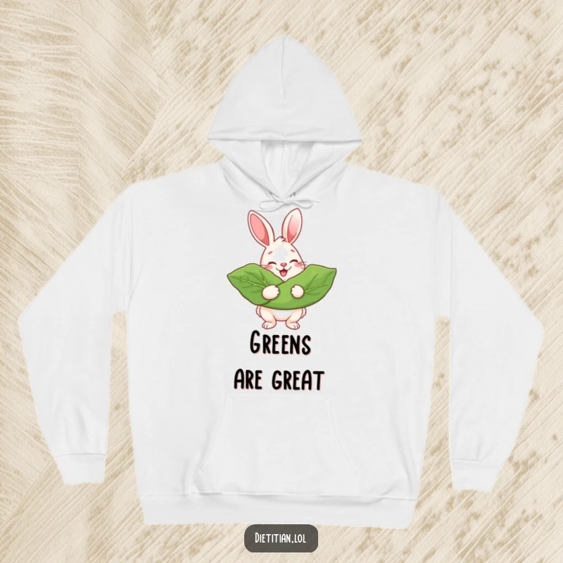 Funny Hoodie depicting a beaming rabbit proudly holding a large, lush leafy green, perfect for cozy days.
